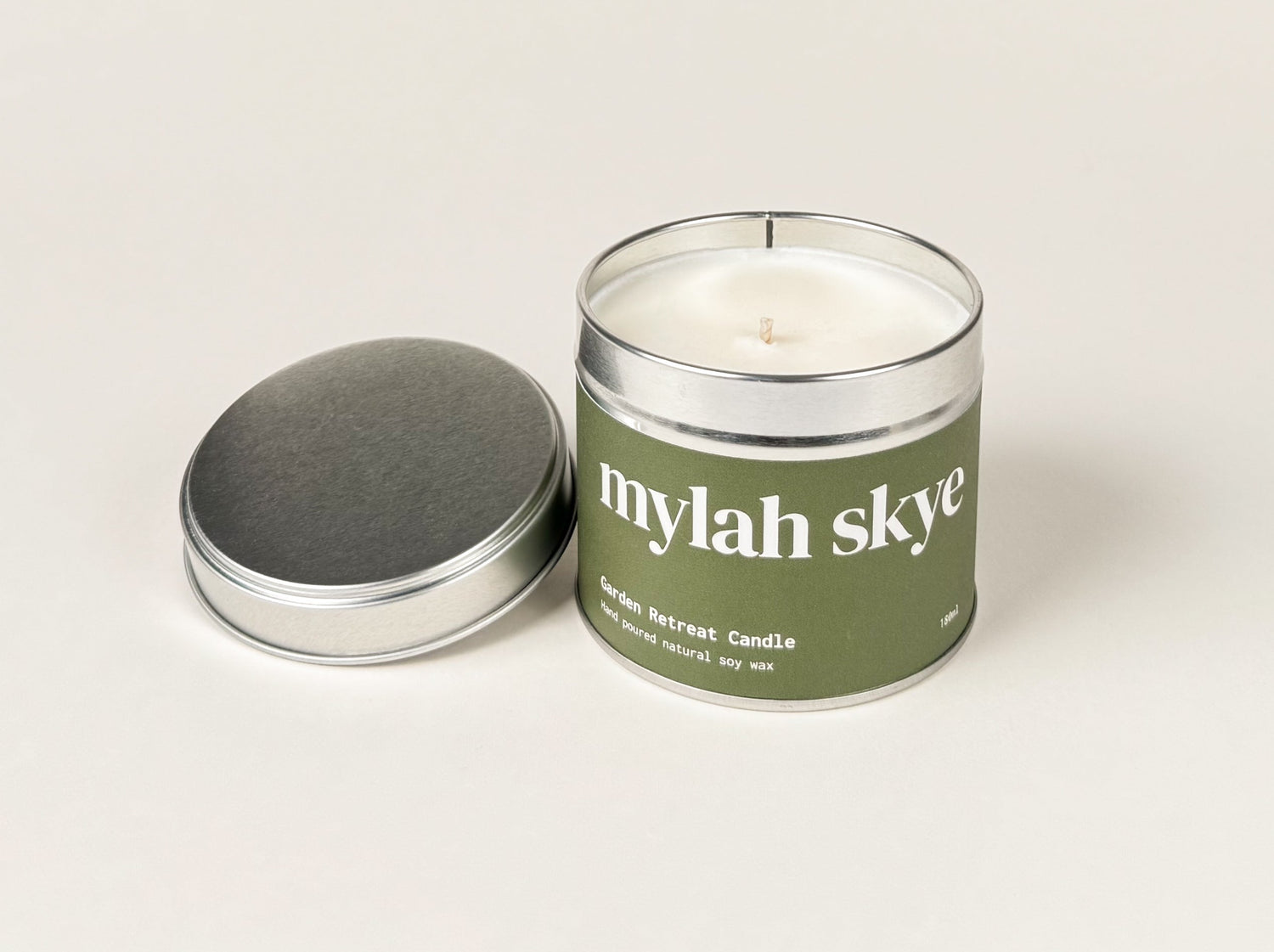 Photograph of a candle tin against an off white background